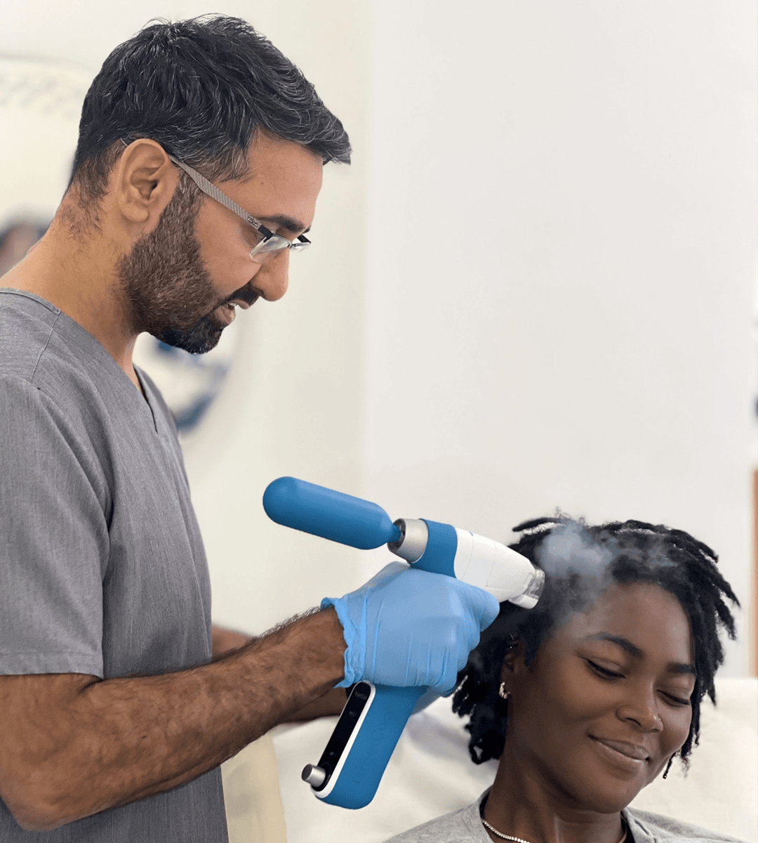 Dr. Baldeep Farmah performing a hair treatment procedure